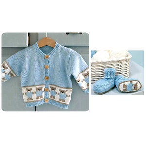 May include: A light blue knitted baby cardigan with a row of brown teddy bear appliques and wooden buttons. Matching light blue knitted baby booties with brown teddy bear appliques are also shown.