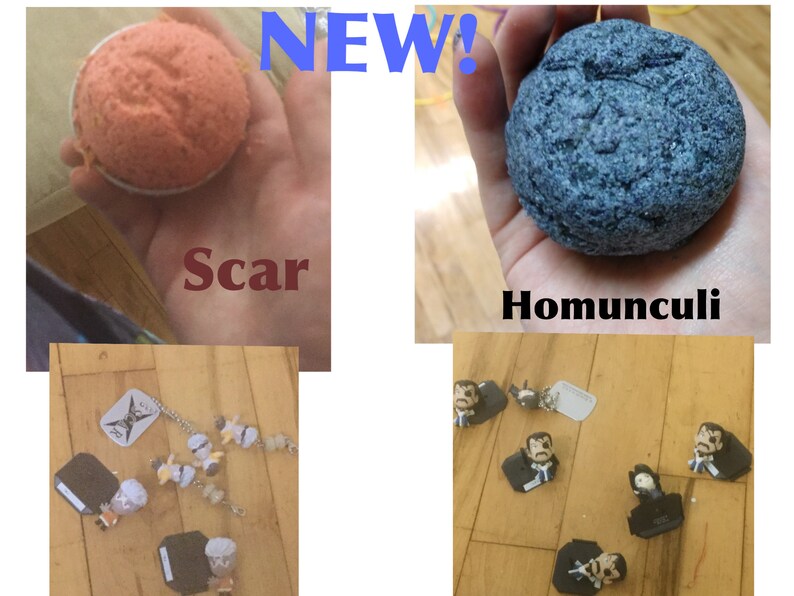 May include: The image showcases a collection of items. One is a round, orange bath bomb labeled "Scar." Another is a blue, textured bath bomb called "Homunculi." There are also small figurines and charms scattered on a wooden surface. The word "NEW!" is displayed.
