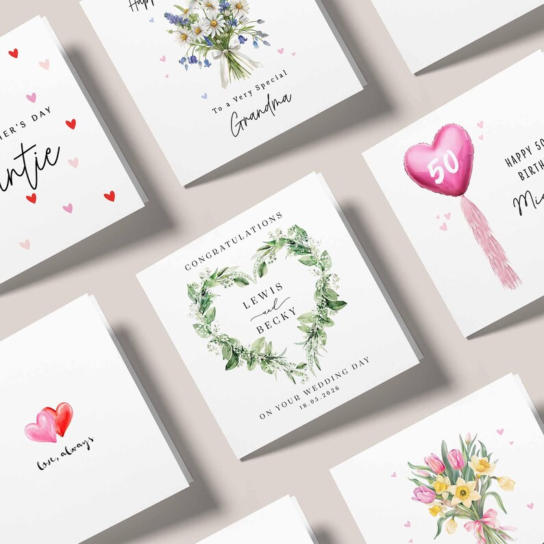 May include: A selection of greeting cards with different designs. Some cards display floral arrangements, a heart-shaped balloon, and the text "Happy 50th Birthday". Other cards include messages such as "To a Very Special Grandma" and "Congratulations Lewis and Becky".