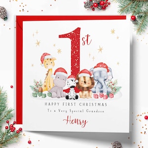 Op de afbeelding: Een vierkante wenskaart met een groot rood cijfer 1st, omringd door aquarelillustraties van een giraf, nijlpaard, zebra, leeuw en olifant met kerstmutsen. Tekst: Happy First Christmas To a Very Special Grandson Henry.