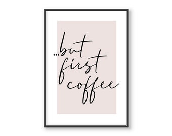 May include: A black framed print with a light pink background and the text "...but first coffee" in black cursive writing.