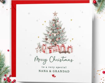May include: A square white greeting card featuring a watercolour illustration of a decorated Christmas tree with pinecones and ornaments, surrounded by wrapped gifts. The text reads Merry Christmas to a very special NANA & GRANDAD with two small red hearts.