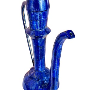 May include: A blue ceramic pitcher with a spout and handle, made of small, mosaic-like pieces of lapis lazuli.