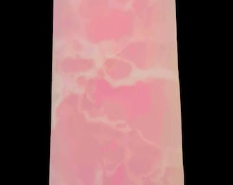 May include: A pink crystal point with white and light pink swirls. The crystal is shaped like a pyramid with a pointed top.