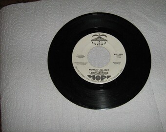1960s promo rock & roll 45 rpm  Leigh Ashford on Hop # 45-11001  ( the country's got a soul all its' own ) flip side is ( workin all day )