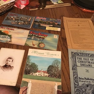 May include: A collection of vintage postcards and pamphlets, including images of Rock City Gardens, West Virginia, Silver Springs, Mount Vernon, and The Isle of Christmas Dreams. The postcards are in various colours and feature scenic landscapes and historical landmarks.