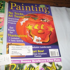 May include: A magazine cover featuring a painted pumpkin with a star and crescent moon design. The magazine is titled "Painting" and the cover text says "No Tricks, All Treats!" and "Get Ready for Thanksgiving".