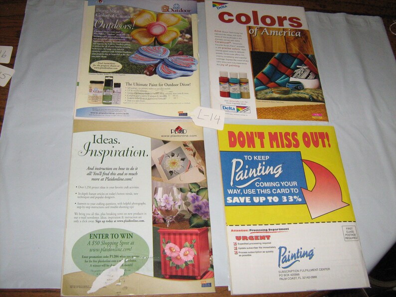 May include: Four magazine pages featuring painting supplies and instructions. The first page shows a colourful flower painted on a wooden surface with the text "Outdoor Colorful Creations Outdoors!" The second page shows a painting of a blanket with the text "Colors of America". The third page shows a painting of a flower in a glass vase with the text "Ideas. Inspiration." The fourth page shows a yellow and red sign with the text "Don't Miss Out! To Keep Painting Coming Your Way, Use This Card To Save Up To 33%"