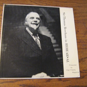 May include: Black and white photo of Sir Thomas Beecham in rehearsal, presented by High Fidelity Magazine.