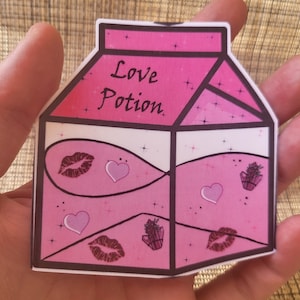 May include: A pink and white milk carton sticker with the words 