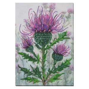 May include: A close-up of a purple and green beaded thistle flower with a white background.