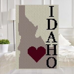 May include: A crochet blanket with the outline of the state of Idaho and the word "IDAHO" with a red heart in the center.