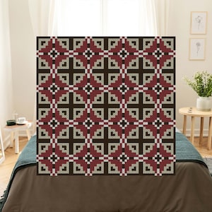 May include: A brown, beige, and burgundy geometric patterned throw blanket with a repeating design.
