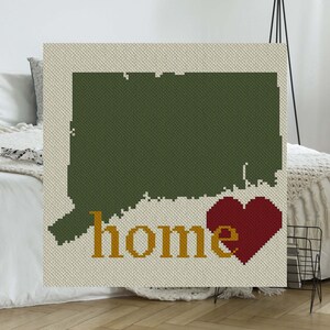 May include: A green outline of the state of Connecticut with the word "home" in yellow letters and a red heart over the "e".