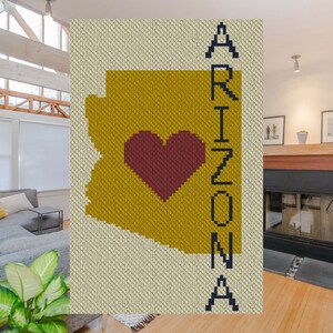 May include: A crochet pattern of the state of Arizona with a red heart in the center and the word "Arizona" spelled vertically on the right side.
