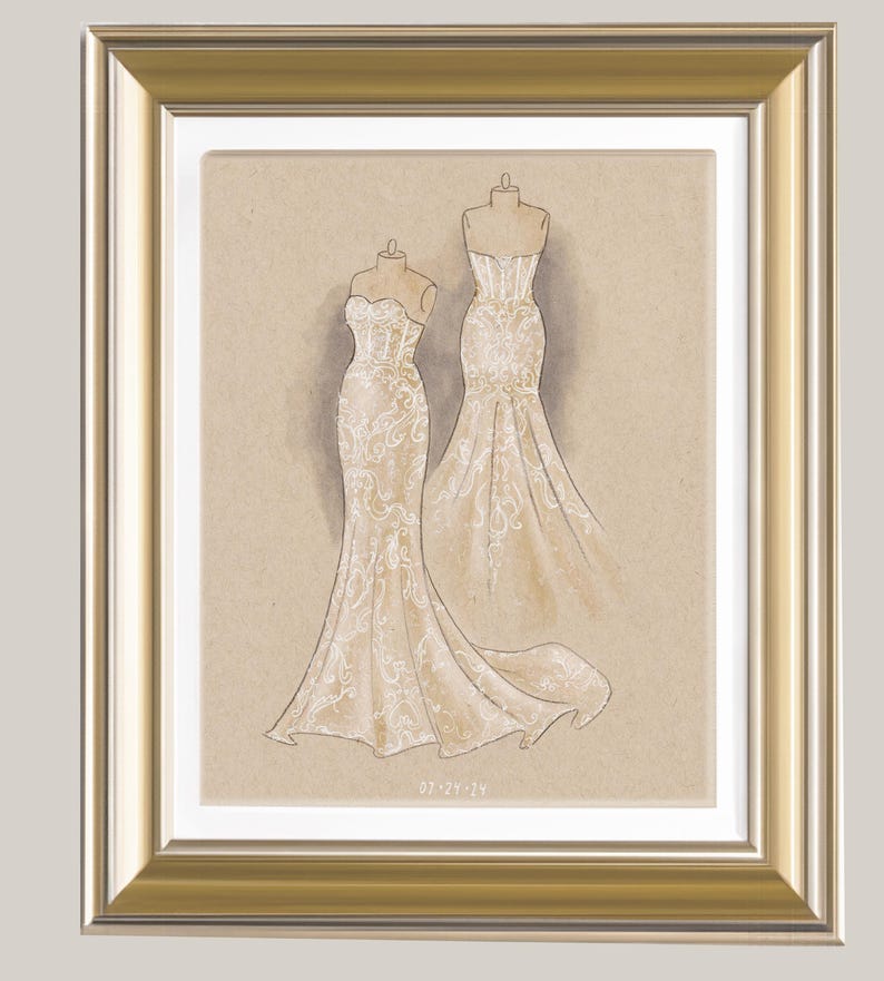 May include: A framed illustration of two wedding dresses with lace detailing. The dresses are drawn on a beige background and the date "07-27-14" is written in the bottom right corner.