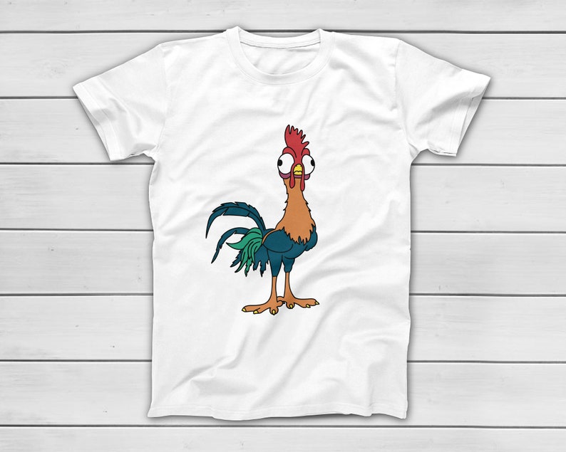 Puede incluir: Camiseta blanca con un dise&ntilde;o de gallo de dibujos animados. El gallo tiene una cresta roja, cuerpo naranja, plumas de cola azules y verdes y ojos grandes. La camiseta est&aacute; hecha de un material suave. El gallo est&aacute; de pie.