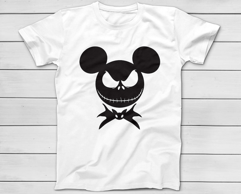 May include: White t-shirt featuring a black silhouette of a character's face with mouse ears, an angry expression, and a bat-shaped bow tie. The design is centered on the shirt, which has short sleeves and a crew neck.