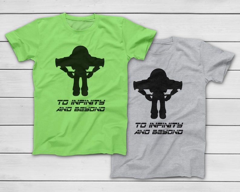 May include: Two short-sleeved t-shirts, one lime green and one gray, each featuring a black silhouette of a space ranger with the text "TO INFINITY AND BEYOND" below. The shirts are likely made of cotton.
