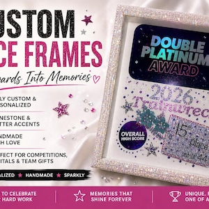 May include: Custom dance frame with rhinestone and glitter accents. The frame displays a "Double Platinum Award" for "Trainwreck" in 2026, with a 15th place out of 44. The frame is fully personalized and handmade.