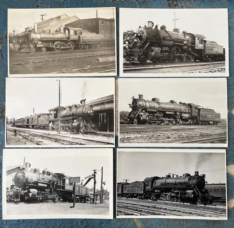 May include: A collection of six vintage black and white photographs featuring steam locomotives. The images showcase various angles and designs of the trains, capturing their presence on railroad tracks and near train stations. The photographs are a nostalgic look at rail travel.