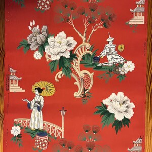 May include: A roll of wallpaper with a red background featuring a repeating pattern of white peonies, green pine trees, pagodas, and figures in traditional clothing. Text on the edges includes "MADE IN U.S.A.", "MATCH", "LOT", and "TOP".