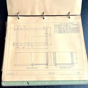May include: Open notebook with architectural drawings of a drawer. The drawings include dimensions in inches and a bill of materials listing mahogany, whitewood, and masonite. The scale is 1/4 = 1.