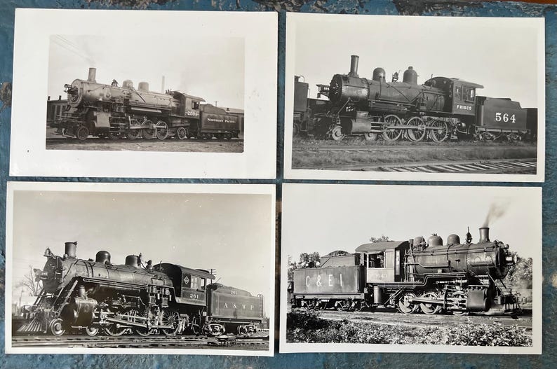May include: Four black and white photographs of steam locomotives. Each image shows a different locomotive, with details of the wheels, smokestacks, and cabs visible. The photographs are arranged in a square format.