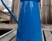 French provencial style enamel pitcher. This rusty, chippy pitcher has loads of french country charm. White interior with rich blue outside.