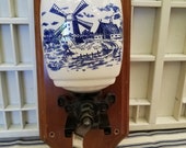 Beautifully decorated blue and white ceramic based coffee grinder. This Dutch look wall mounted coffee grinder has great Farmhouse appeal