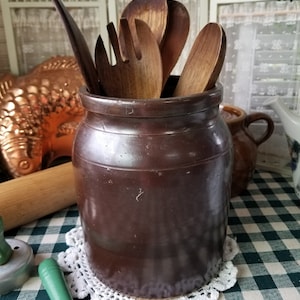 Primitive stoneware farmhouse crock. This dark brown aged antique crock would be a great Gathering Spot for kitchen utensils.
