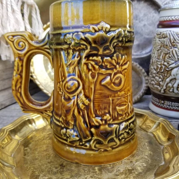 Gorgeous mid-century oversized ceramic beer stein. This Hunters theme ceramic tankard is done in delicious mid-century Golds and greens.