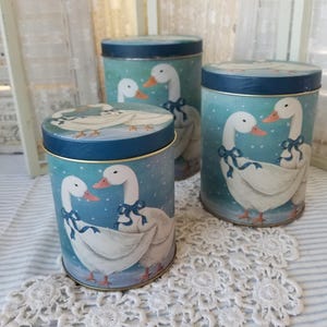Vintage B&D Blue bow goose nesting tins. These three vintage 1970s blue and white nesting tins feature sweet country geese.