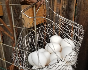 Vintage handled wire basket perfect for Gathering eggs. This adorable opening wire basket is large enough for up to three dozen eggs.