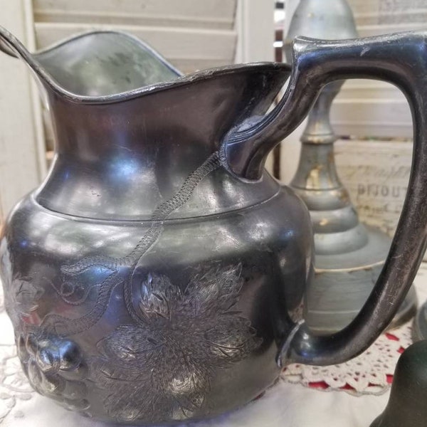 Tarnished antique quadruple plate silver plated pitcher. This delightful ornate silver pitcher is likely a E.G. Webster & Sons creation.