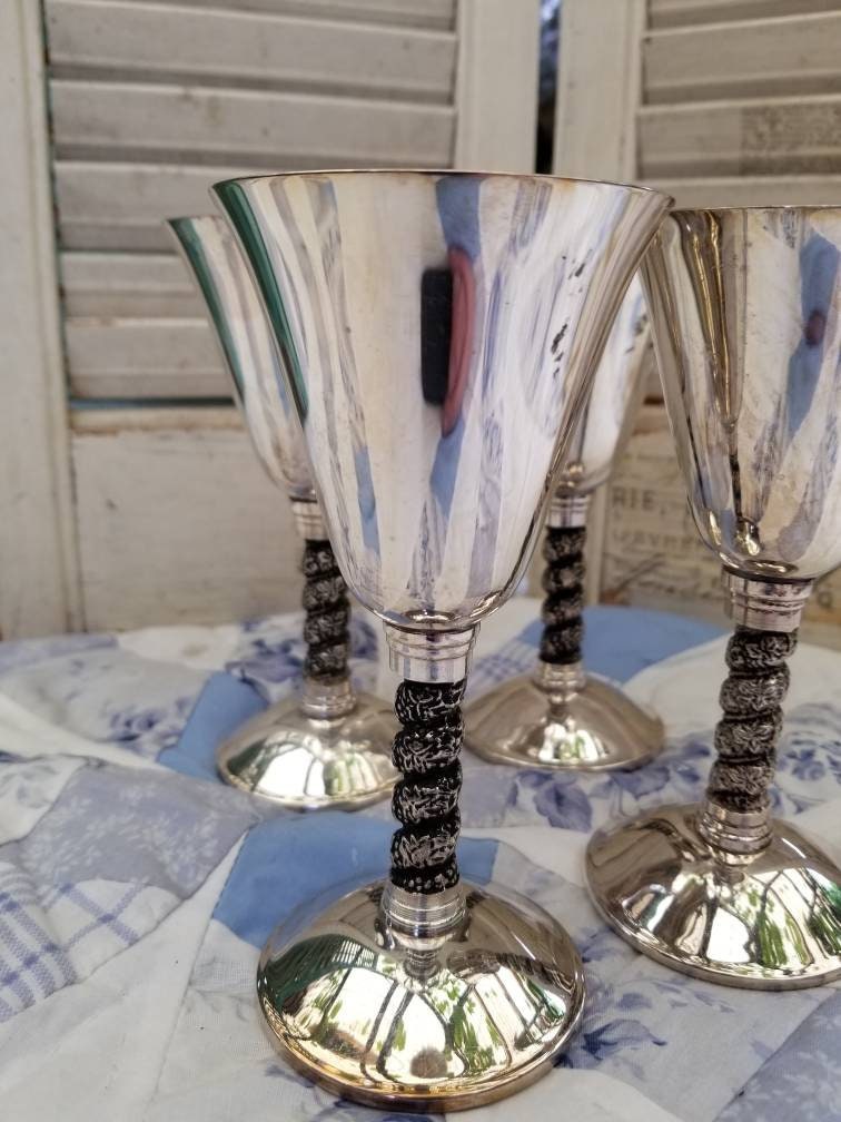 Beautiful and Regal silver plated champagne glasses. This Beautiful and Regal silver plated champagne glasses. This