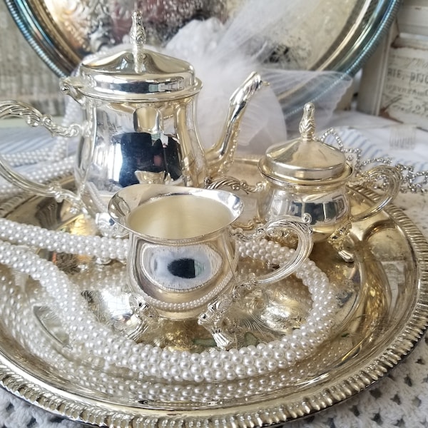 Adorable and delicate silver plated tea set. These 5 sweet miniature tea service pieces will make a fine vignette or fancy girl's high tea.