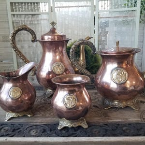 Extraordinary set of beautiful rustic Moroccan gazelle copper and brass coffee and tea service with accompanying creamer and sugar.
