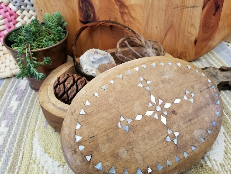 Beautifully primitive hand carved box This hand carved box features inlaid shell design on the top Bohemian eclectic feel on this chest.