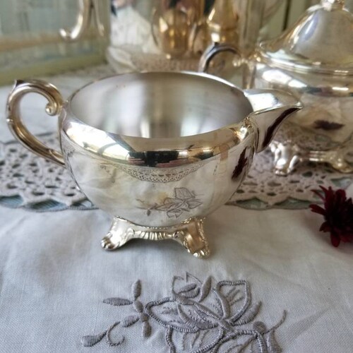 Glorious and gleaming silver plated William Rogers coffee pot and accompanying sugar and creamer. This shops beautiful 3 piece set speaks Elegance