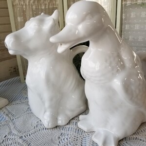 Choose from Farmhouse white ceramic duck or cow pitcher. This barnyard animal pitcher will ad a delightful Farmhouse touch to your kitchen.