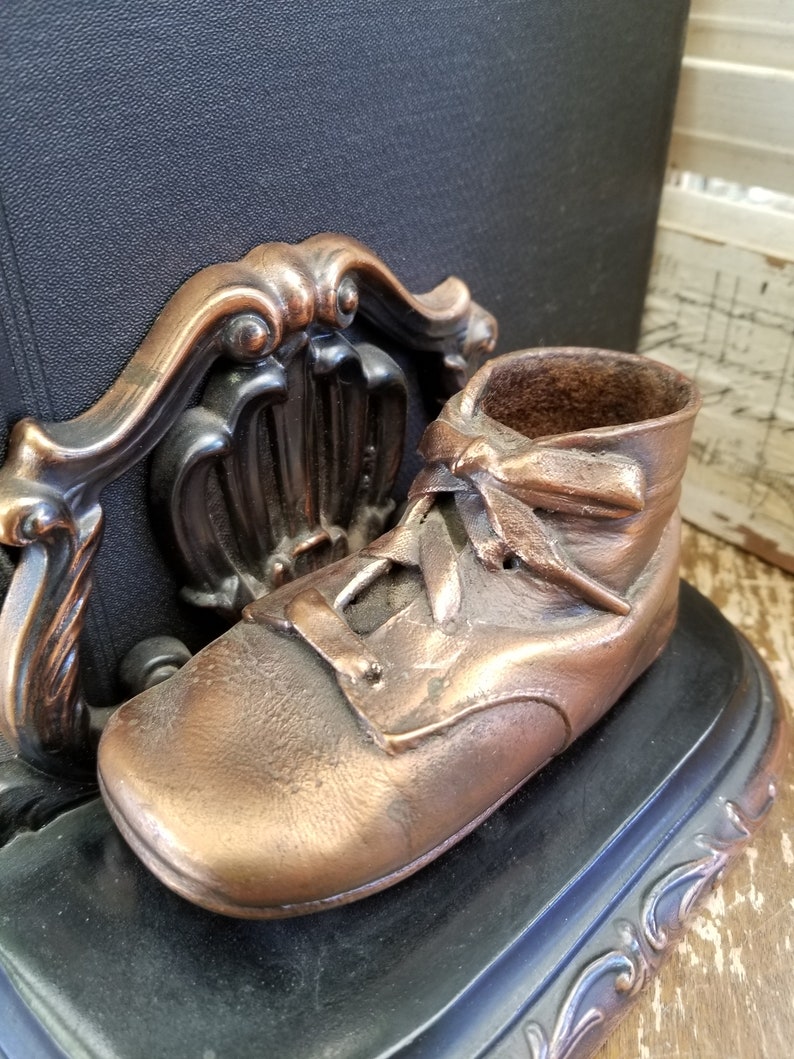 Bronze baby shoes bookends. Remember when these were all the Etsy