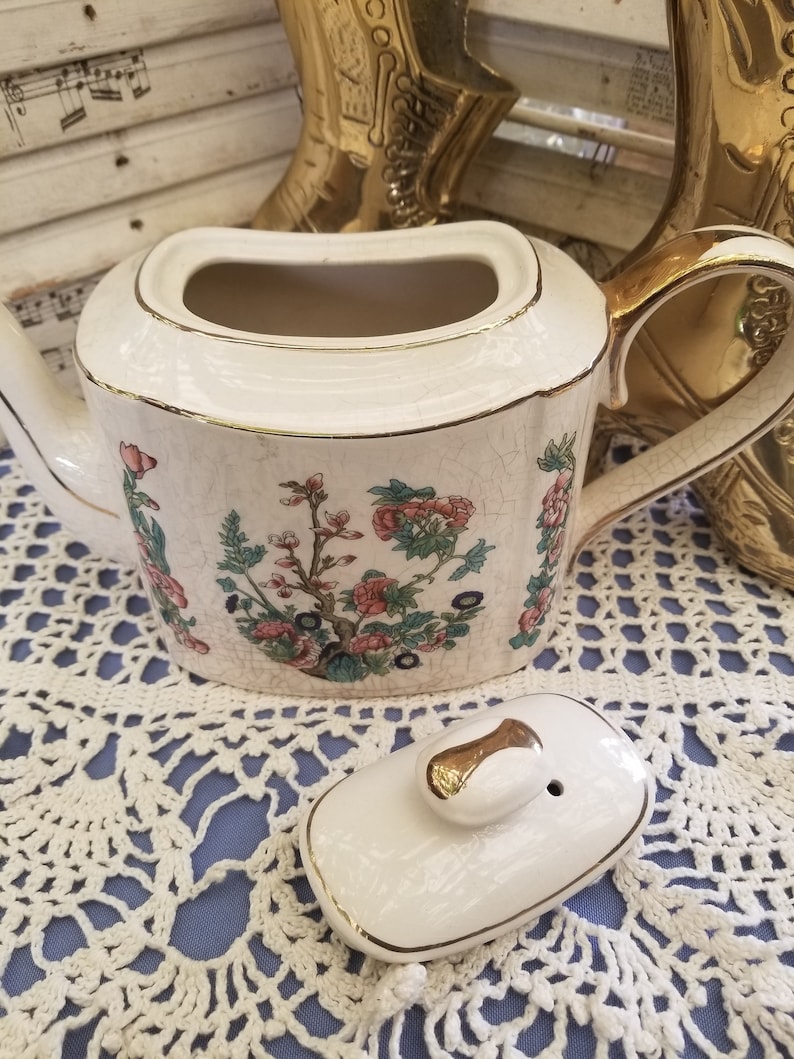Elegant antique gold embellished teapot from Donegal This Arthur Wood antique English china teapot features beautiful floral designs.