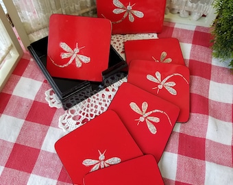 Stylish set of six lacquered dragonfly coasters. These beautiful red and black coasters are adorned with a raised mosaic designed dragonfly.