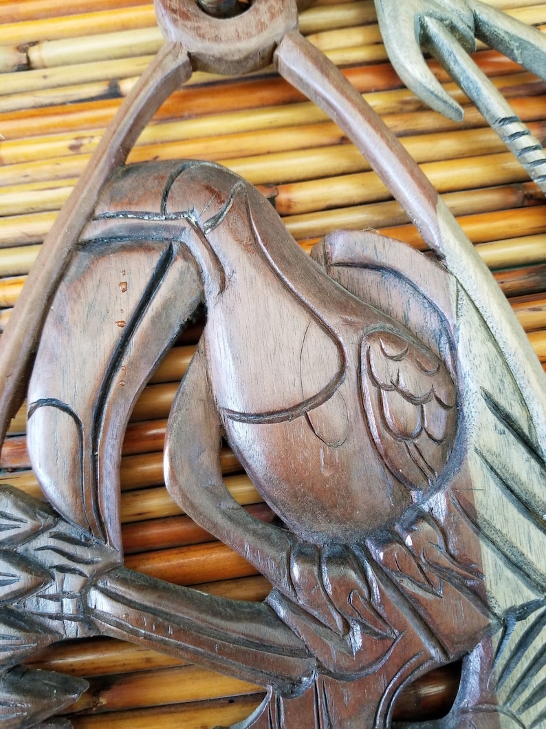 Beautifully hand-carved tropical themed wall hanging Ideal for a jungle or Tiki Room This 3 piece wall hanging features a toucan and fish