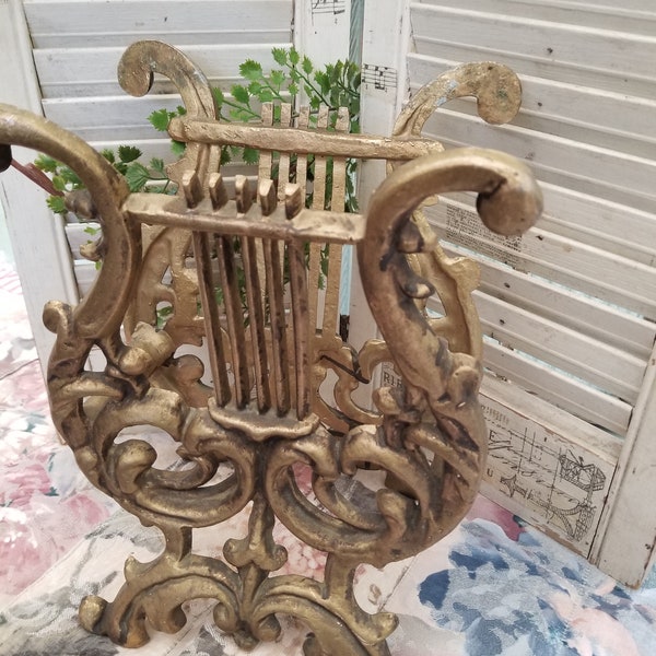 Victorian era reproduction cast aluminum music stand. This piece would add a shabby chic, French country touch to any room. It looks brass.