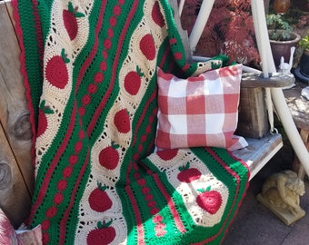 This gorgeous boho red, green, and tan Afghan, with a smattering of red apples, will be perfect for cozying up during apple picking season.