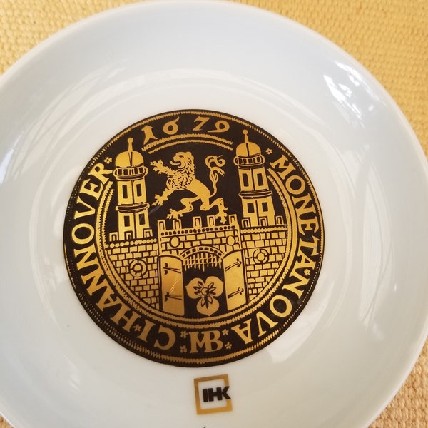A unique trio of IHK porcelain dishes crafted in Hannover, Germany. Each of the 3 gold gilded plates recognize antique German coins.
