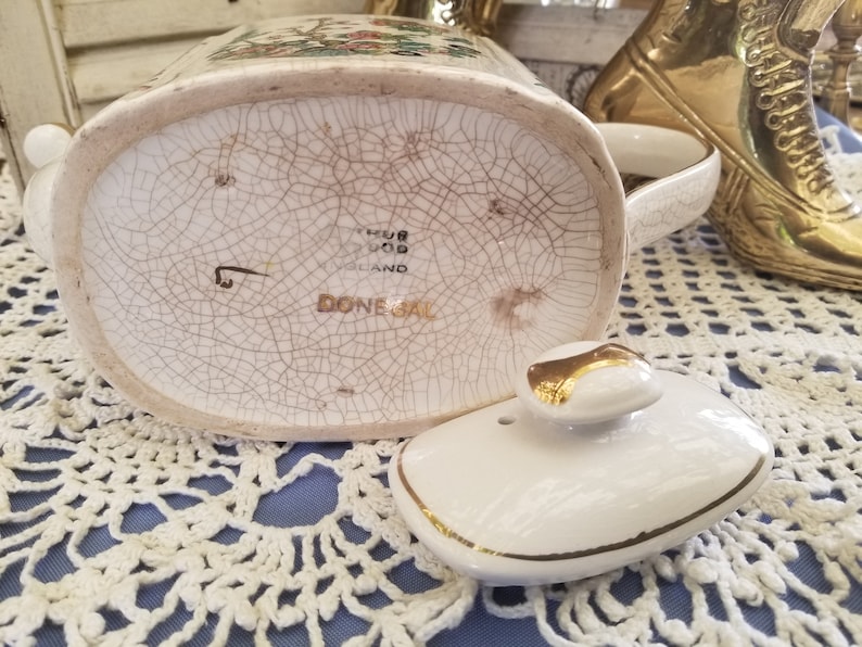 Elegant antique gold embellished teapot from Donegal This Arthur Wood antique English china teapot features beautiful floral designs.