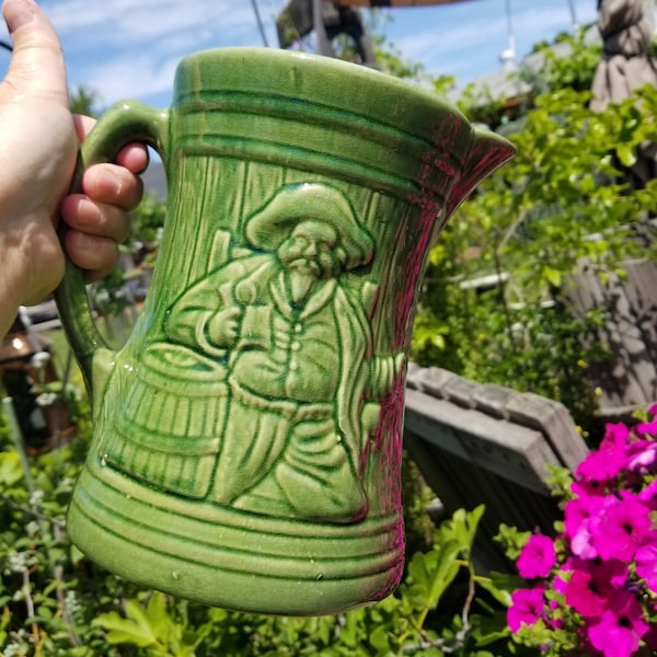 Gorgeous green antique McCoy Pottery buccaneer pitcher. This rare 1920s era McCoy pirate pottery tankard pitcher has Shield Mark 6.